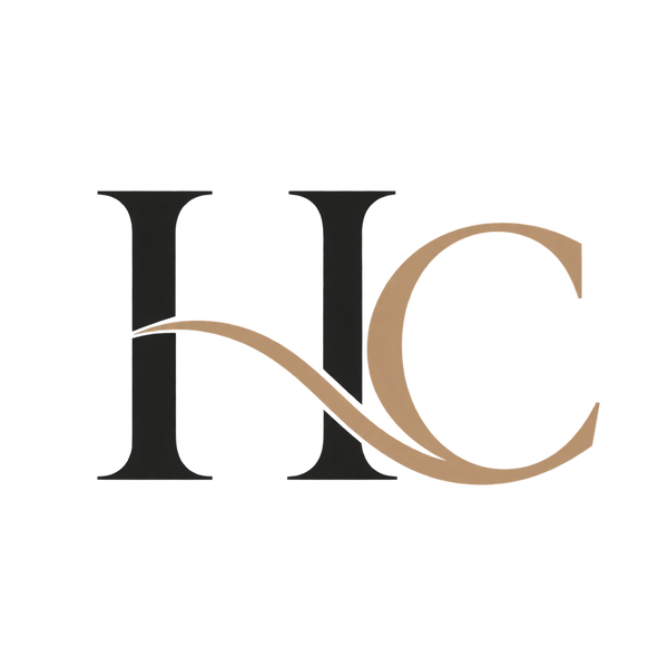 A stylized monogram logo reading 'HC' with a dark charcoal-black serif 'H' and a tan serif 'C' connected by a flowing tan line, centered on a plain white background.