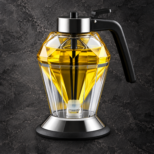 Faceted glass dispenser filled with golden liquid, with a black lever handle and silver-colored lid and base.