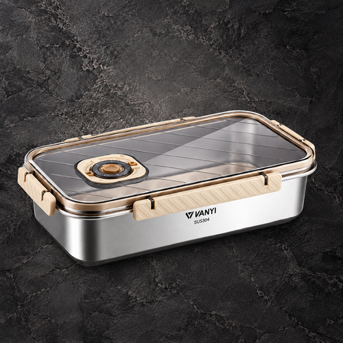Vanyi S2204 stainless steel lunch box with a clear lid, light wood-grain handles, and a gold-toned latch, shown on a dark textured stone background.